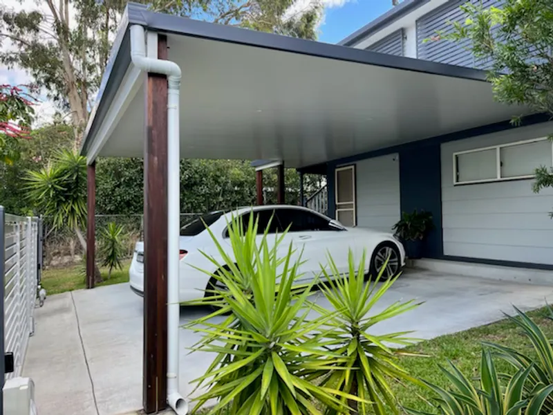 Modern insulated double carport with timber posts and dark cladding